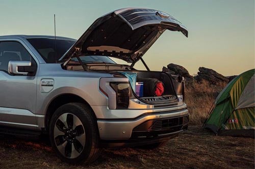 A 2024 Lightning® pickup with the front trunk open full of camping gear